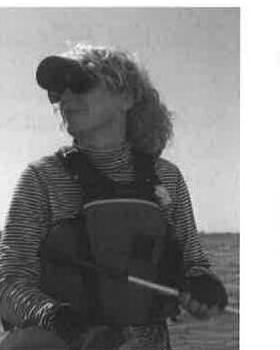 A sailor in a cap and life jacket aboard an Albacore