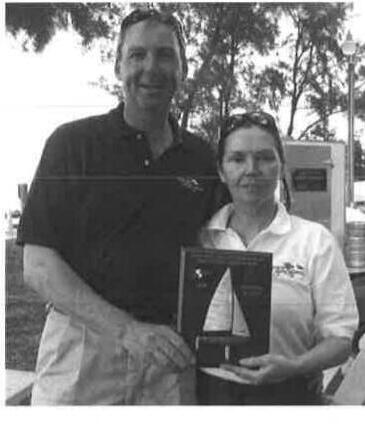 Two sailors posing with an award plaque at the Sarasota Mid-Winters