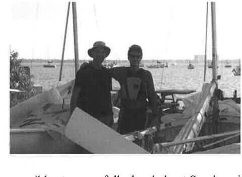 Two sailors standing on a dock among moored boats in Sarasota