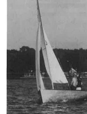 An Albacore sailing on a lake with skipper and crew aboard