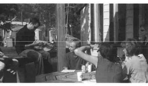 Workshop participants gathered around an outdoor table for a land session