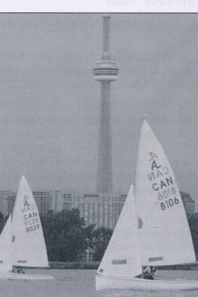 Two Albacores sailing on Lake Ontario with the CN Tower and Toronto skyline behind them