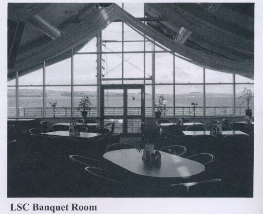 Interior of the Largs Sailing Club banquet room, with tent-like draped ceiling and floor-to-ceiling windows overlooking the harbour