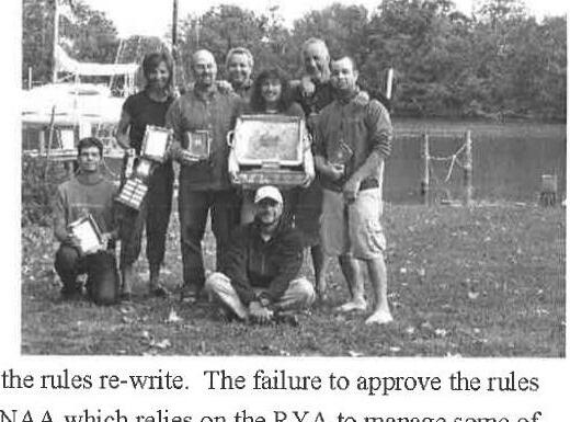 A group of Albacore sailors posing on grass with trophies and plaques after the IAA meeting