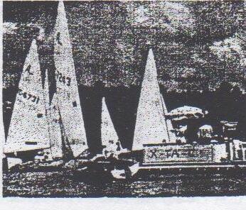 Several Albacores, including KC 6731, sailing past the anchored committee boat