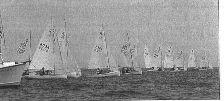 A long line of Albacores lined up at the start, with a keelboat in the foreground