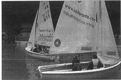 Two Albacores sailing close together indoors at night at the Ricoh Centre