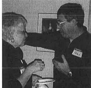 Two attendees chatting at the party