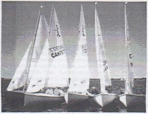 Five Albacores sailing bow to bow in a tight line, apparently on dry land