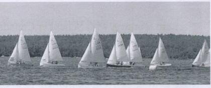 A fleet of Albacores racing on a lake