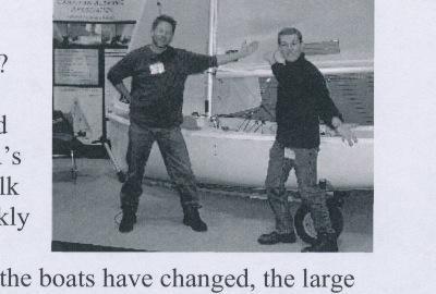 Two men posing beside the new Ontario Yachts Albacore at the CAA's booth at the Toronto Boat Show