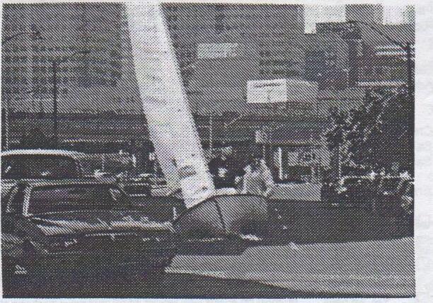 An Albacore heeled hard over on a downtown Toronto street among parked cars