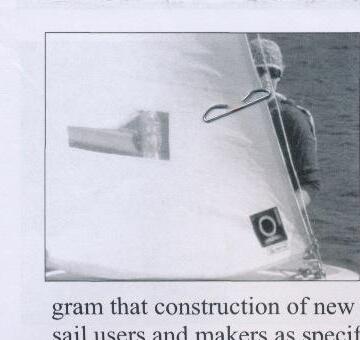 Close-up of a jib window on a sail, with a rigging shackle in the foreground