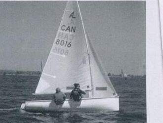 An Albacore, sail number CAN 8016, sailing with two crew aboard