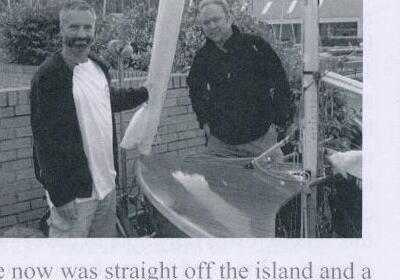 Barney Harris and Dave, sailing master at Largs Sailing Club, standing with a boat