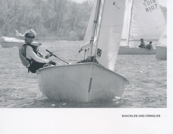 A woman single-handing an Albacore close to camera, with two more Albacores racing behind