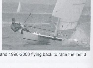 A sailor hiking hard on a single-handed Dart dinghy, spray flying from the bow
