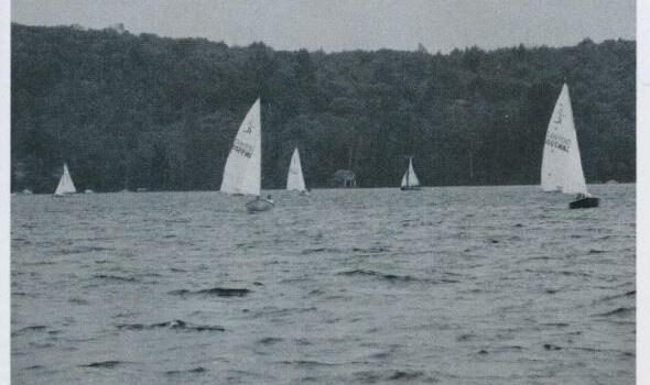 Several Albacores racing on Mary Lake with the village of Port Sydney in the background