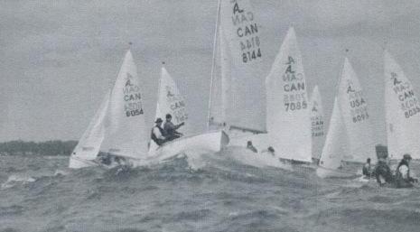 Five Albacores sailing together in choppy waves