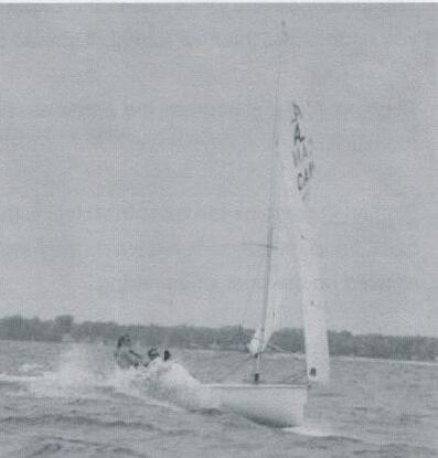 An Albacore surfing down a wave with two crew visible
