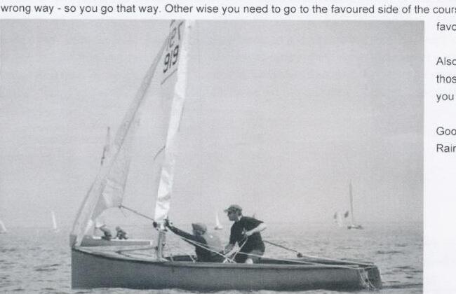 An Albacore numbered AL 919 sailing with helm and crew aboard, other boats visible in the distance