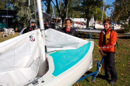 Rachel Harris and Timma Flanagan standing with a rigged Albacore in a boat park