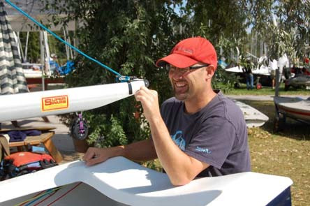 A club member holding up an Albacore hull marked with sail number 26
