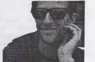 Chris Gorton in dark sunglasses, hand to his cheek