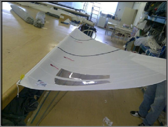 A finished sail laid out on the loft floor for inspection