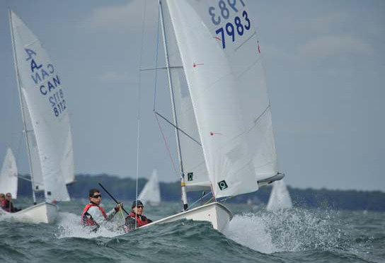 Two Albacores planing hard downwind, sail numbers 7983 and 8112 visible