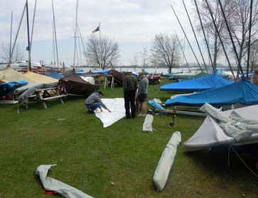 Boats and covers laid out on the grass at the Outer Harbour during CAA Day