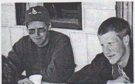 Bob Stiff and his son seated at a table in the OHCC clubhouse