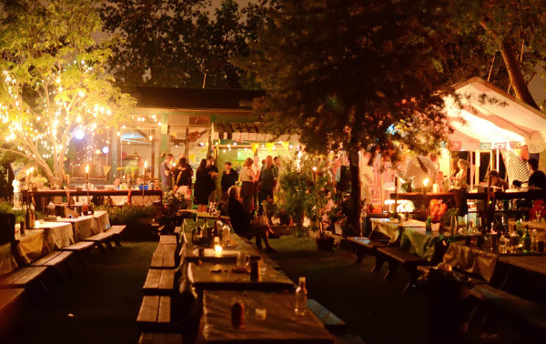 A twilight patio dinner strung with lights at a sailing club