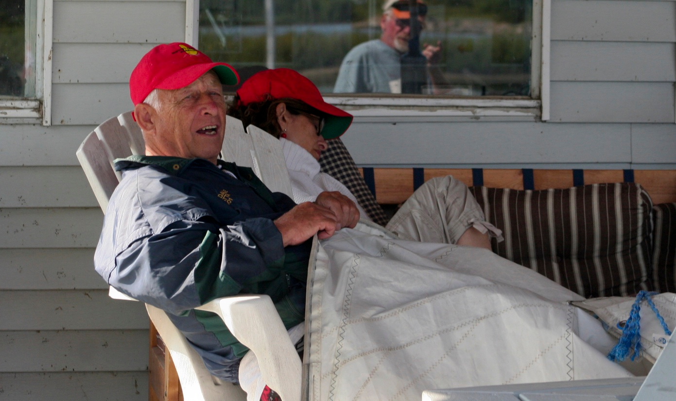 Derek Shenstone relaxing in an Adirondack chair on a clubhouse porch