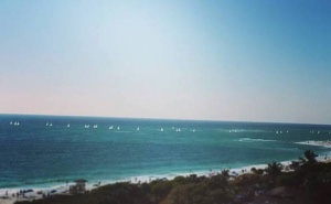 View of Sarasota's Siesta Key beach with distant Albacore fleet racing