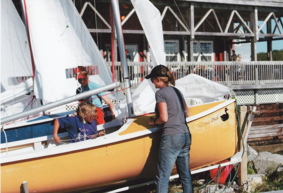 Volunteers rigging a yellow Albacore named Stormy Duck at Shelburne Harbour