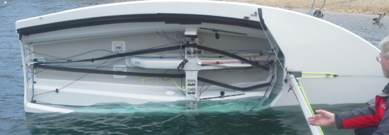 A row of new Albacore hulls lined up on a dock