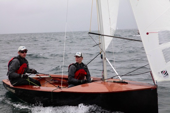 Two sailors racing an Albacore in grey conditions