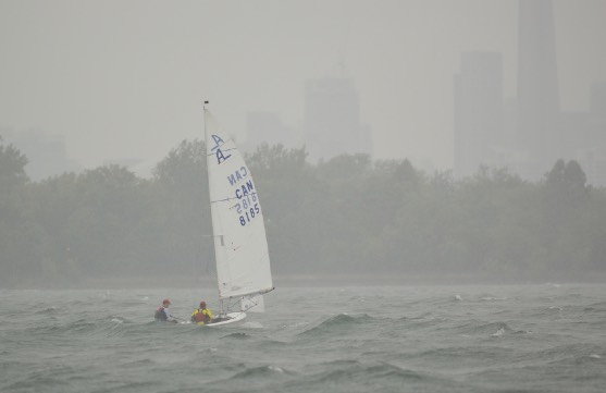 An Albacore sailing in fog with the city skyline barely visible