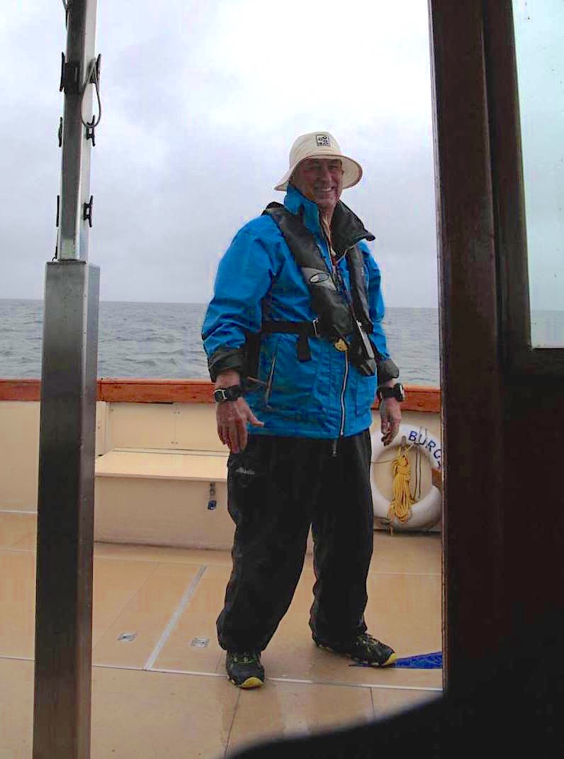 David Sprague, PRO, on the committee boat in foul weather gear