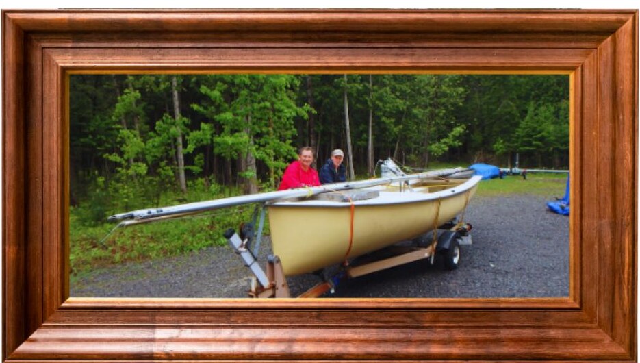 Adam Kubik accepting a boat donation from Tom Saunders