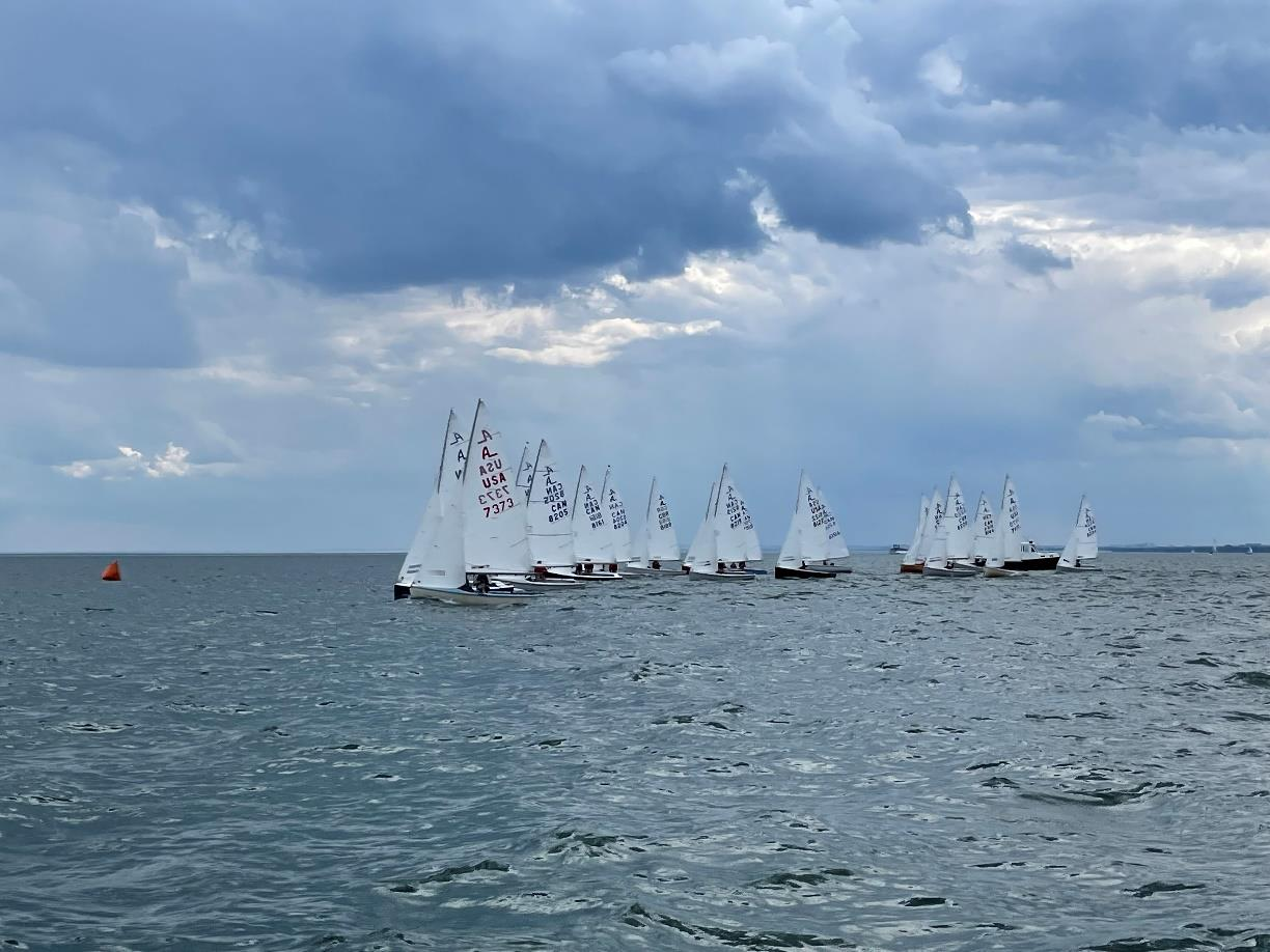 Albacore fleet at the start line under a dramatic sky