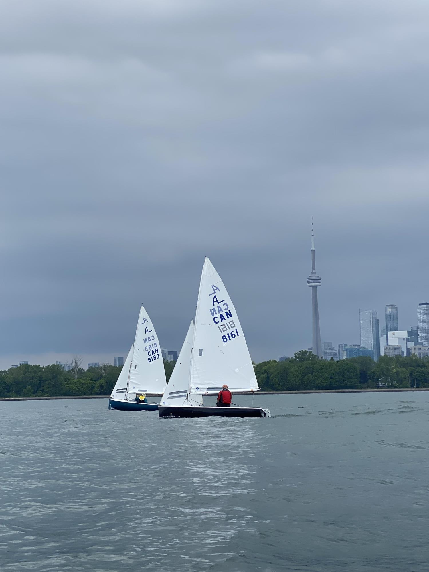 Two Albacores racing off Toronto with the CN Tower behind