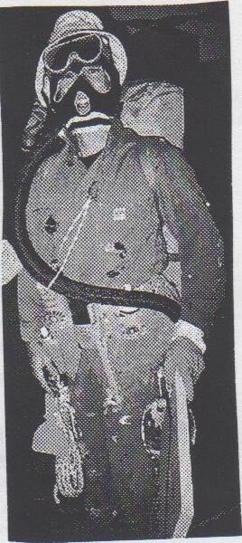 A sailor in a hooded suit wearing goggles, a gas mask with a hose, gloves and a whistle — the “Lincoln Sunday Sailing and Survival Suit”