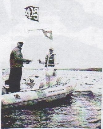 Nick Jaco and Peter Jones standing in an inflatable committee boat
