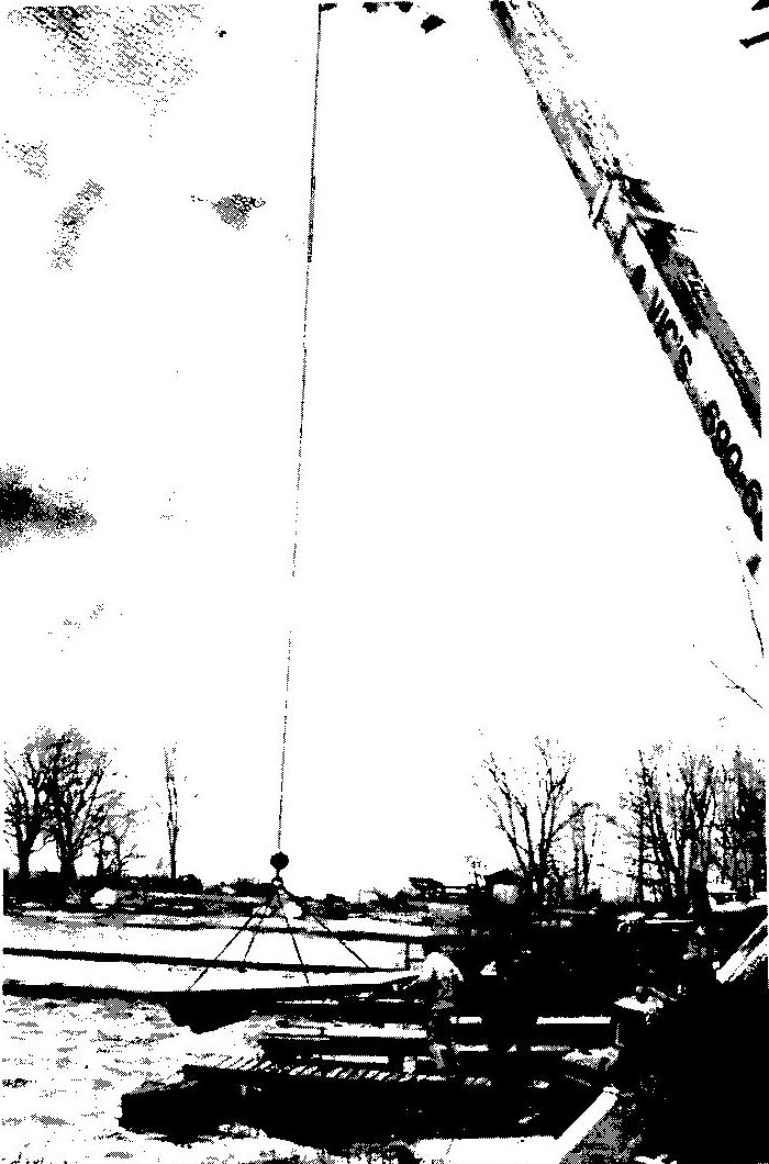 Black-and-white cover photo of an Albacore with its sail up, tied to a dock beside bare winter trees