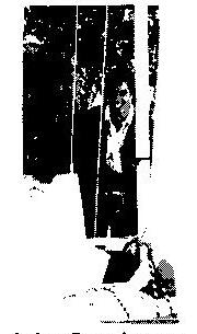 John Cawthorne seen in a high-contrast photo beside a hull