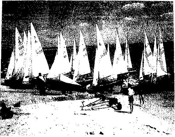 Albacores with sails up crowding the beach while launching at Hayling Island Sailing Club