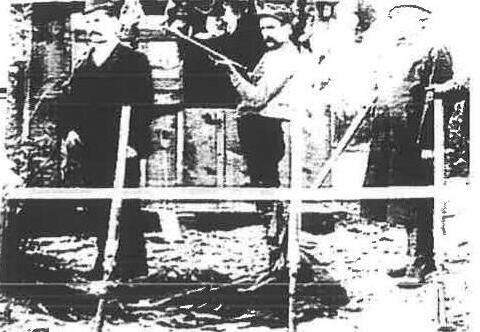 Archival photo of men with long guns standing in a punt or blind at Ashbridges Bay