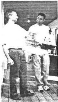 Barney Harris and David Byron chatting on a club deck